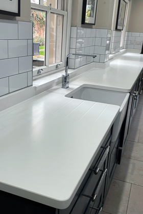 white quartz worktop against subway tiles modern kitchen design