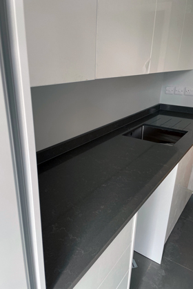 grey speckled quartz kitchen counter top with inbuilt sink